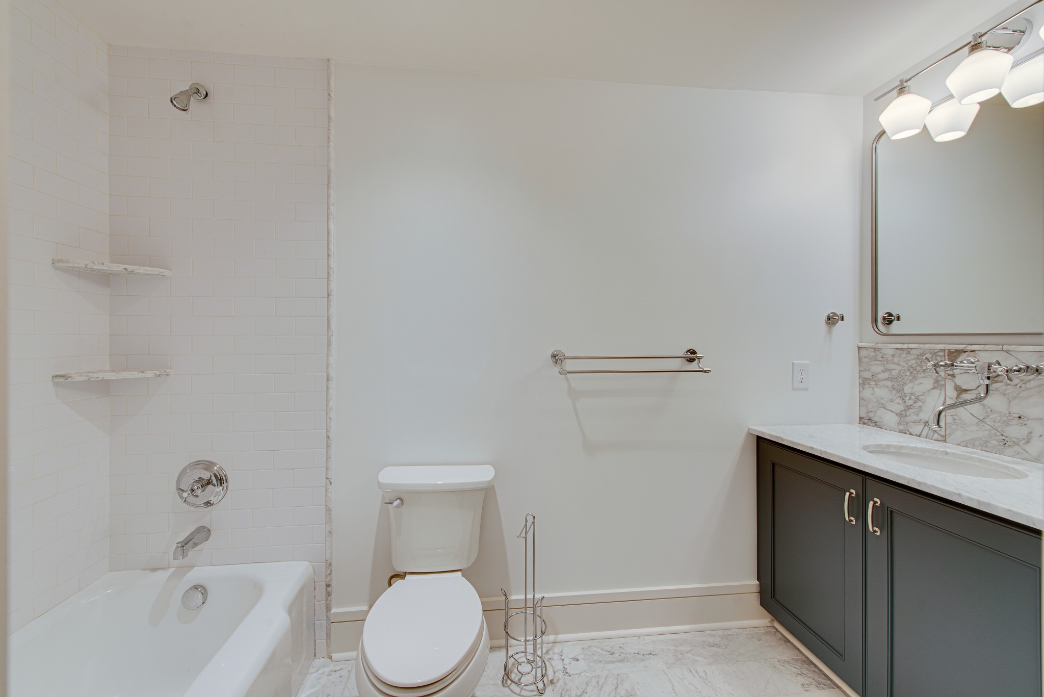 2111 Natchez Trace Nashville, TN 37212 - Photo 28 of 41 a white toilet sitting next to a bathroom sink and tub