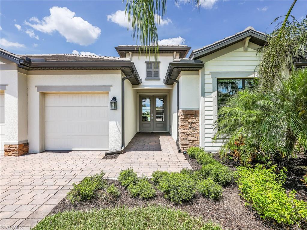 18278 Ridgeline Drive Estero, FL 33928 - Photo 2 of 45 a front view of a house with a garden