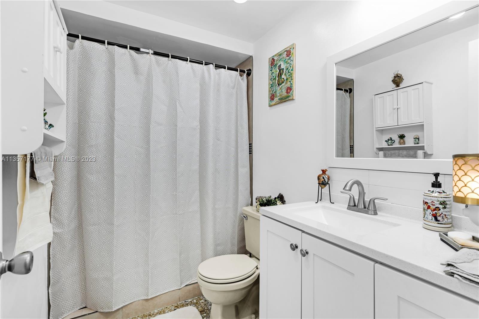 Kendall Miami, FL 33176 - Photo 21 of 35 a bathroom with a sink a toilet and a mirror