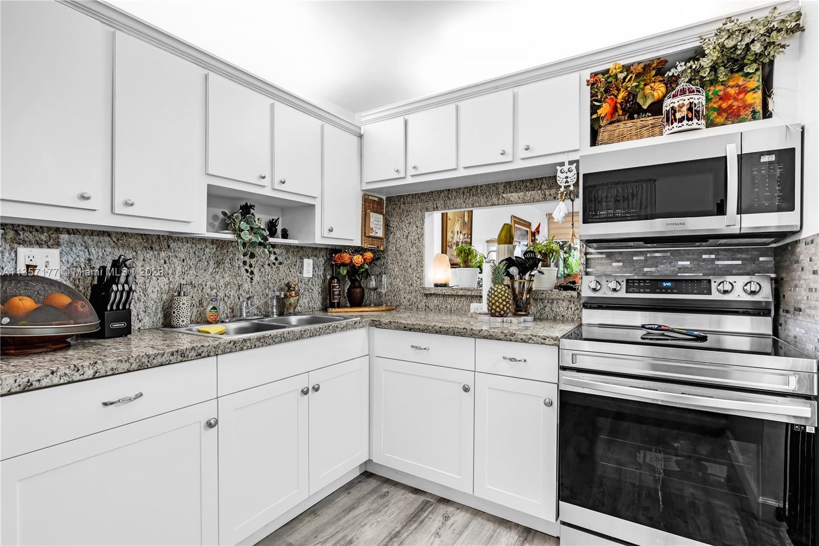 Kendall Miami, FL 33176 - Photo 9 of 35 a kitchen with stainless steel appliances granite countertop a stove a sink and a microwave