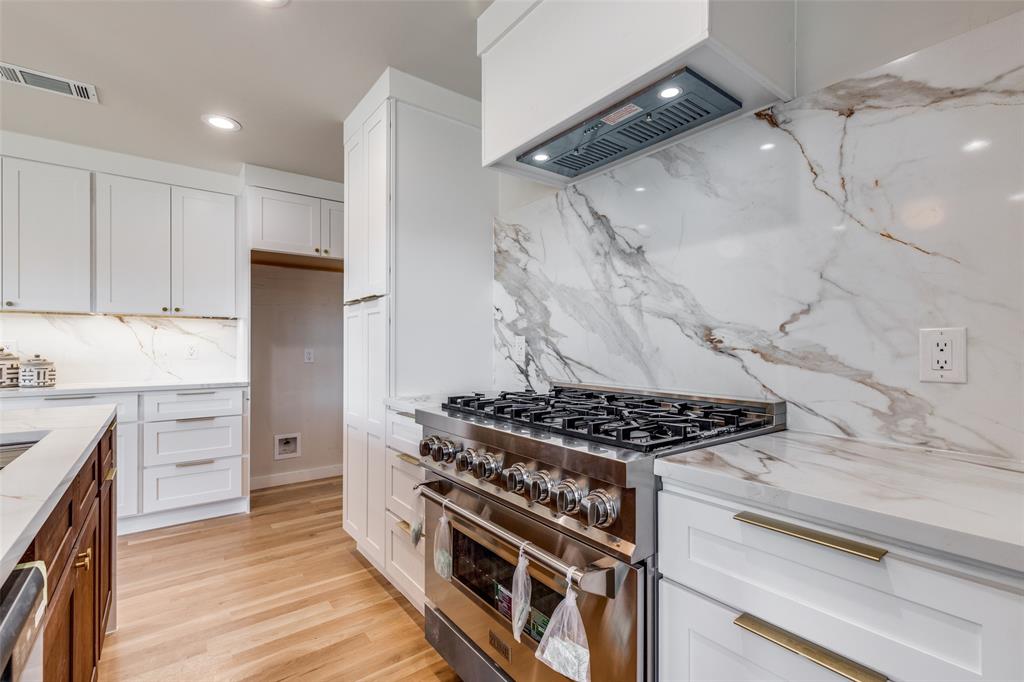 17119 Skelton Place Dallas, TX 75248 - Photo 12 of 32 a kitchen with stove and cabinets