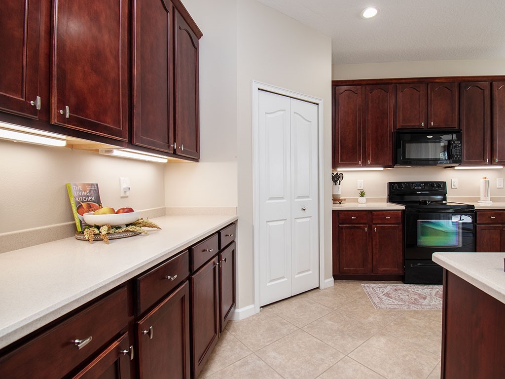 119 Amherst Lane Sebastian, FL 32958 - Photo 11 of 35 a kitchen with stainless steel appliances granite countertop a stove refrigerator and cabinets