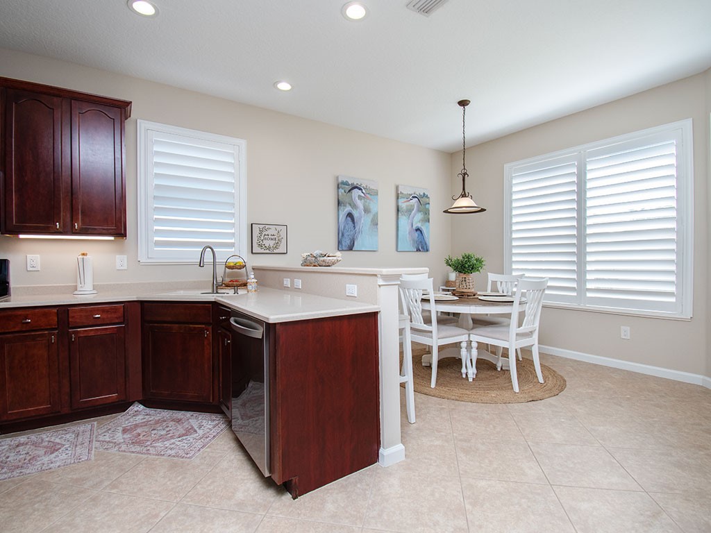 119 Amherst Lane Sebastian, FL 32958 - Photo 14 of 35 a kitchen with a table chairs sink and cabinets