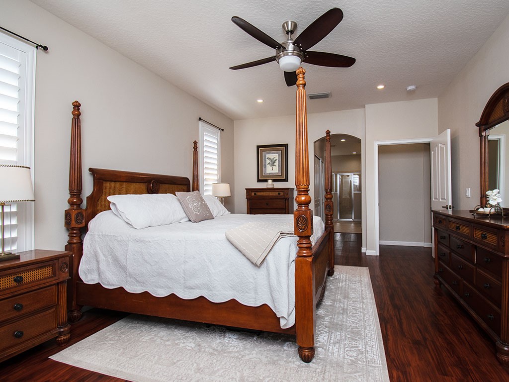 119 Amherst Lane Sebastian, FL 32958 - Photo 19 of 35 a bedroom with a bed and a chandelier