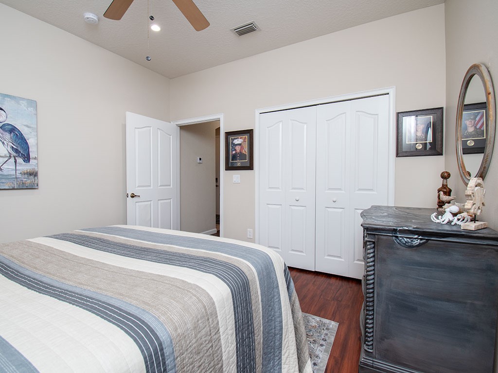 119 Amherst Lane Sebastian, FL 32958 - Photo 25 of 35 a bedroom with a bed and a mirror on the dresser