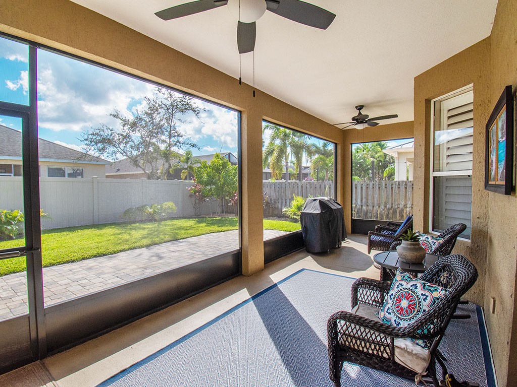 119 Amherst Lane Sebastian, FL 32958 - Photo 30 of 35 a living room with couch and a floor to ceiling window