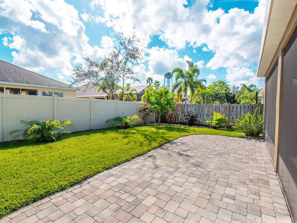 119 Amherst Lane Sebastian, FL 32958 - Photo 33 of 35 a view of a yard with plants and a bench