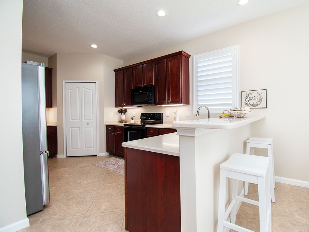 119 Amherst Lane Sebastian, FL 32958 - Photo 10 of 35 a kitchen with a sink a stove a refrigerator and cabinets