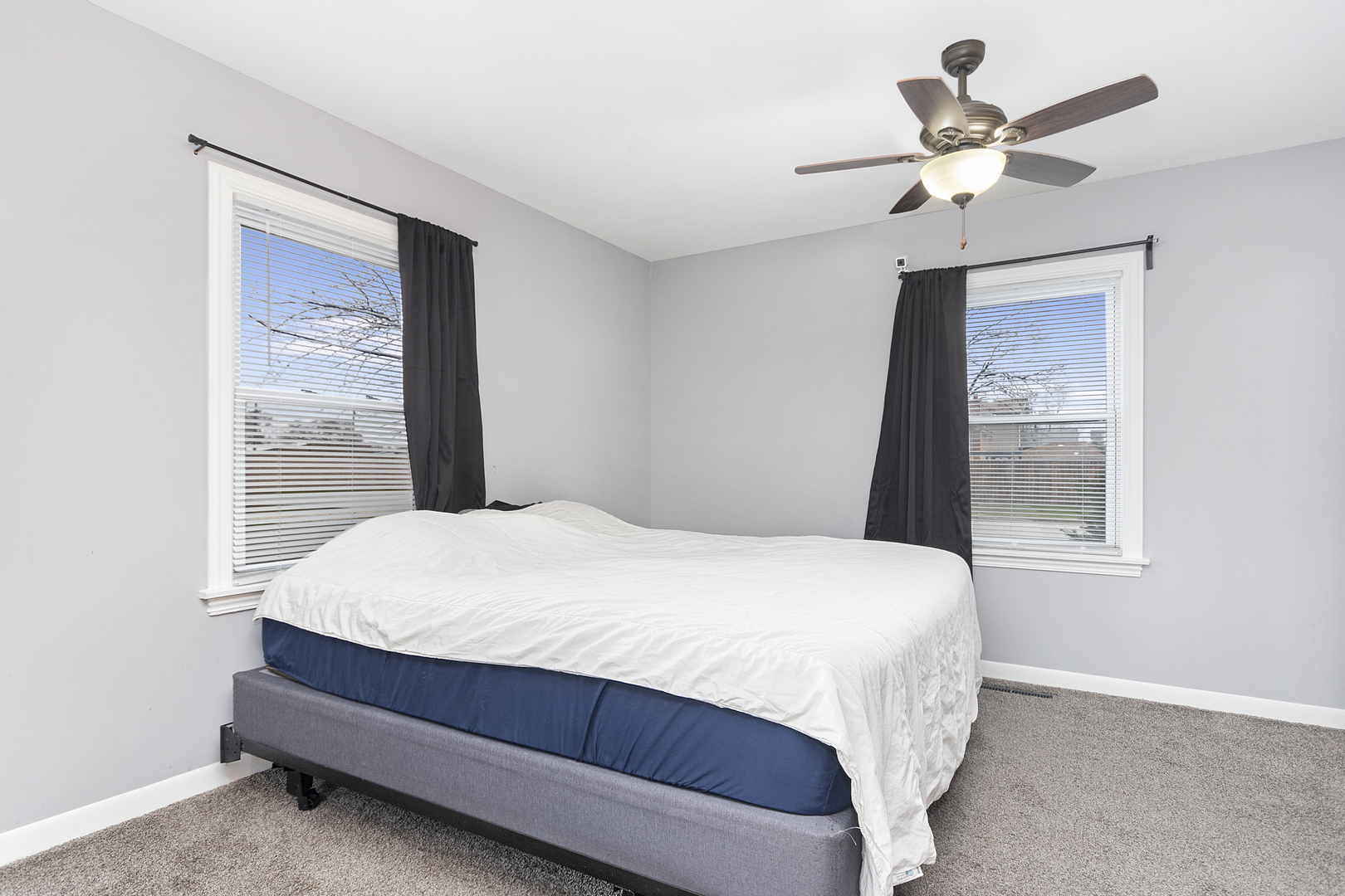 7506 Ferdinand Avenue Bridgeview, IL 60455 - Photo 11 of 14 a bed sitting in a bedroom next to a window