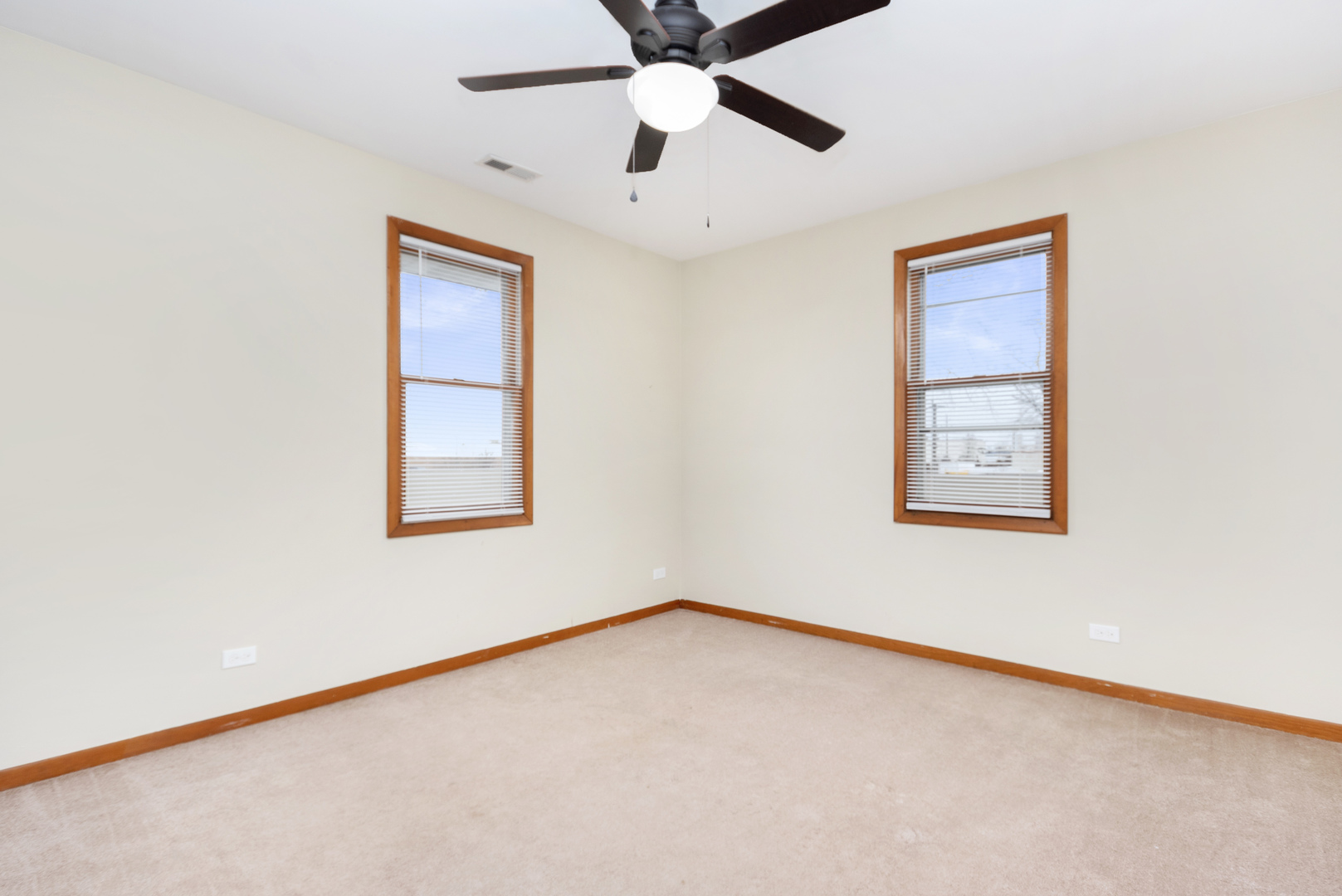 7506 Ferdinand Avenue Bridgeview, IL 60455 - Photo 13 of 14 an empty room with a window and a ceiling fan