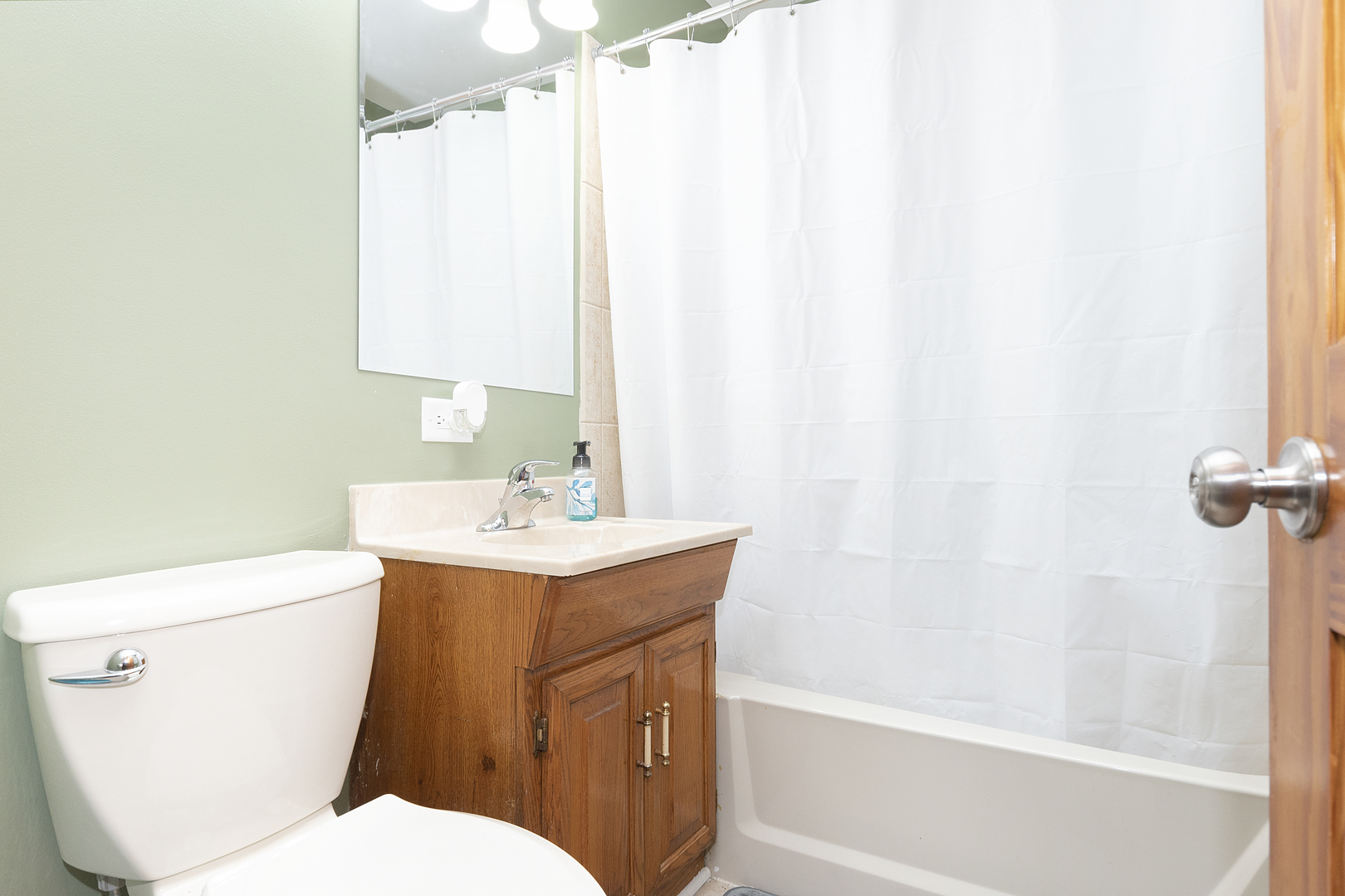 7506 Ferdinand Avenue Bridgeview, IL 60455 - Photo 8 of 14 a bathroom with a sink a toilet and shower