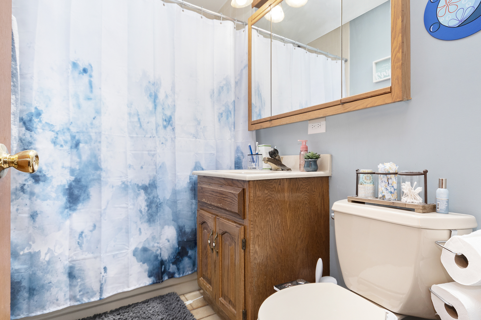 7506 Ferdinand Avenue Bridgeview, IL 60455 - Photo 9 of 14 a bathroom with a toilet sink and mirror
