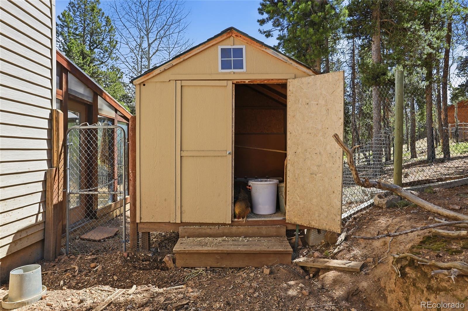 9225 Sandy Lane Conifer, CO 80433 - Photo 40 of 45 a view of a house with a yard