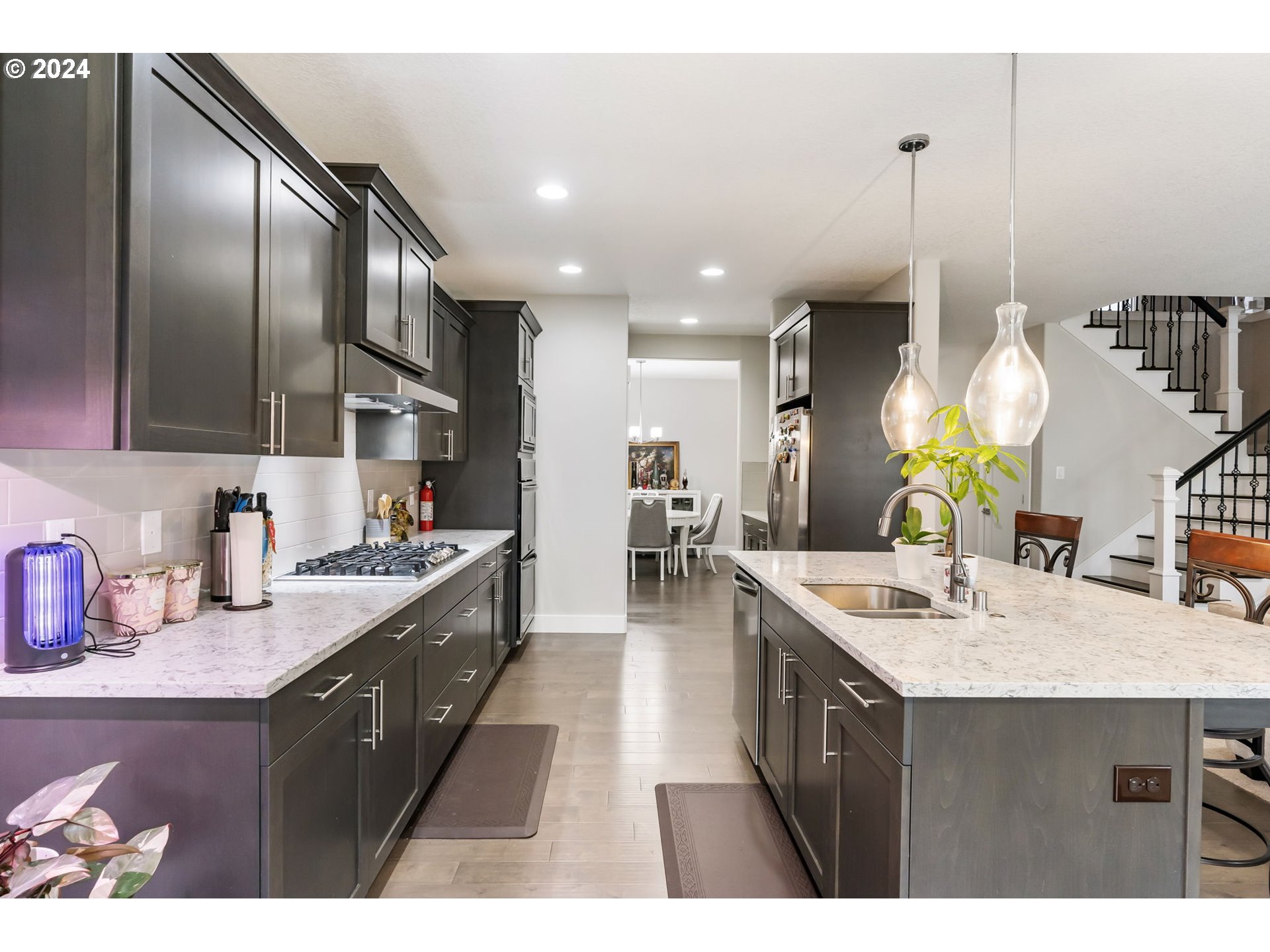 1838 South 46th Place Ridgefield, WA 98642 - Photo 12 of 47 a spacious kitchen with stainless steel appliances granite countertop a sink a stove and a wooden floors