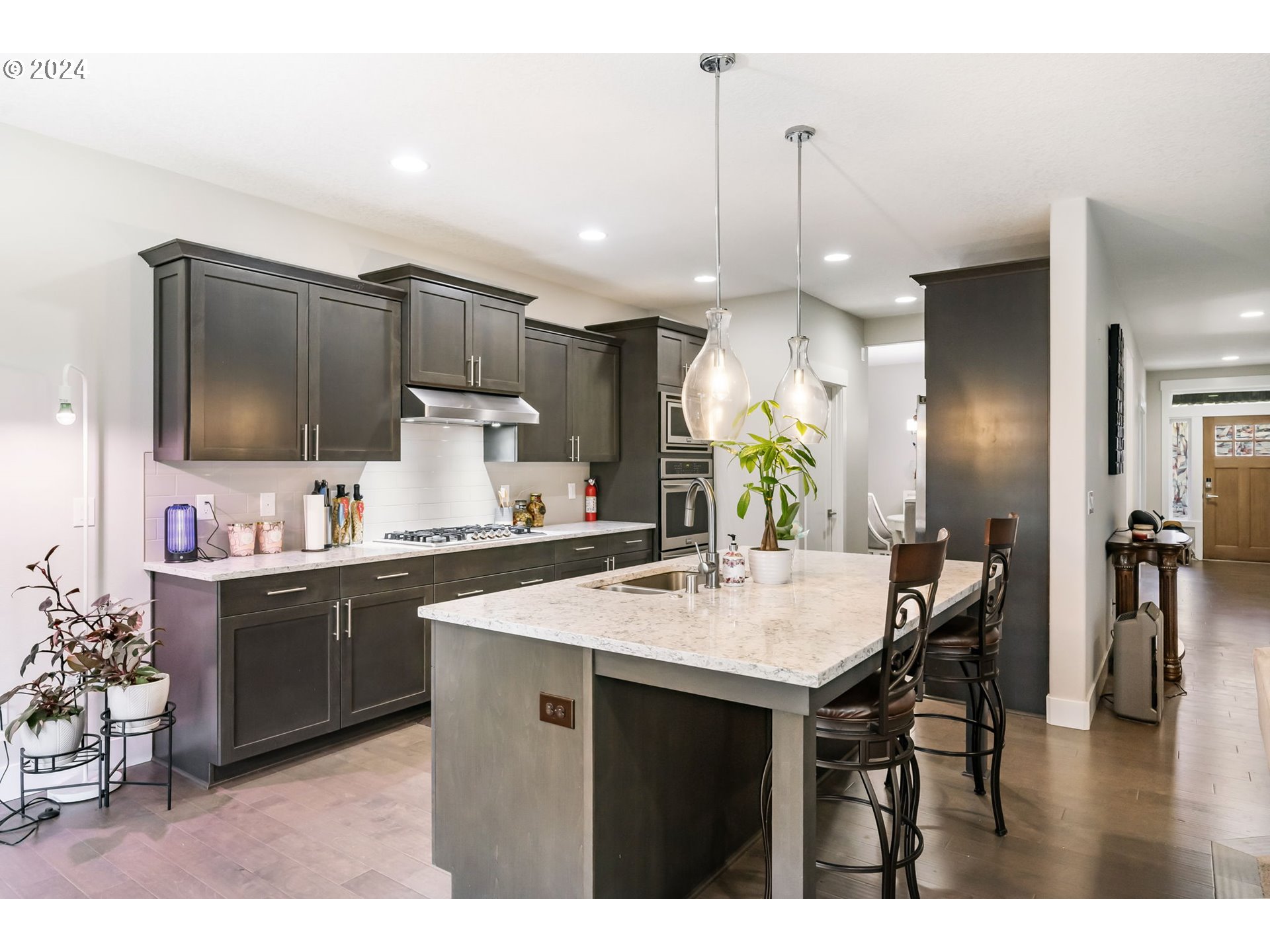 1838 South 46th Place Ridgefield, WA 98642 - Photo 13 of 47 a kitchen with kitchen island granite countertop a sink cabinets and stainless steel appliances