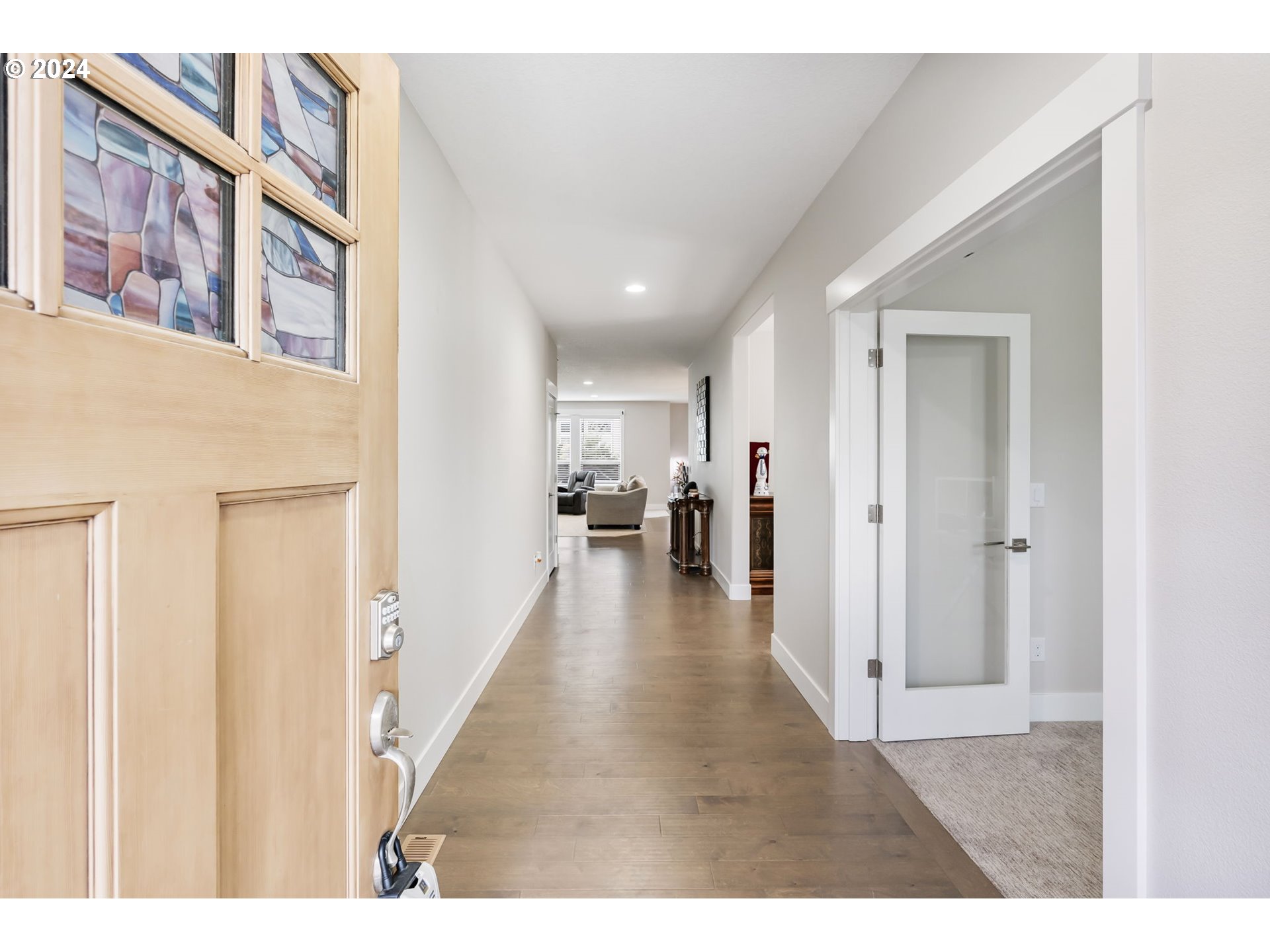 1838 South 46th Place Ridgefield, WA 98642 - Photo 2 of 47 a view of a hallway with wooden floor and a living room