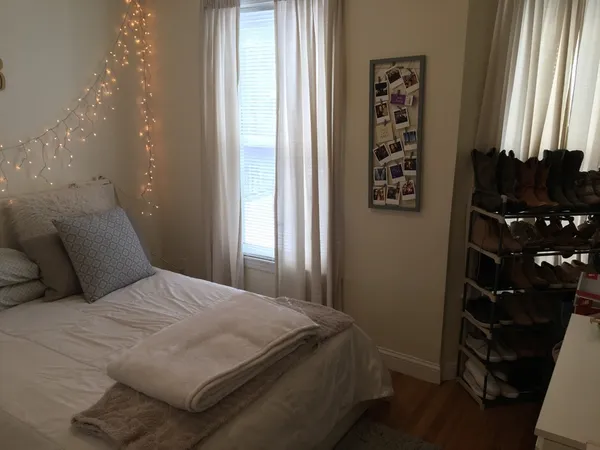 a bedroom with a bed and a window