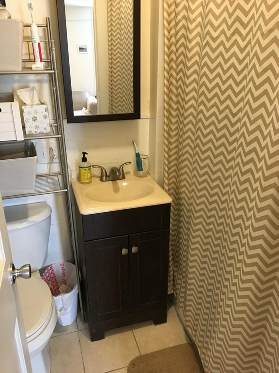 11 Leverett Street, Unit 3 Brookline, MA 02445 - Photo 7 of 7 a bathroom with a sink and a mirror