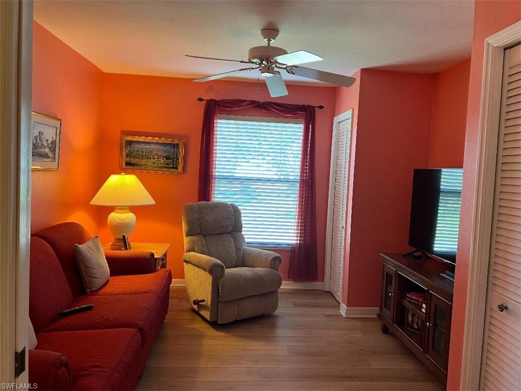 501 Veranda Way, Unit G204 Naples, FL 34104 - Photo 2 of 7 a living room with furniture and a flat screen tv