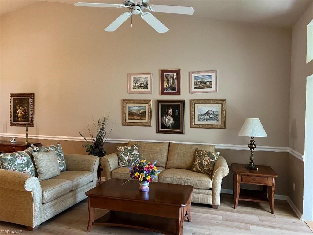 501 Veranda Way, Unit G204 Naples, FL 34104 - Photo 4 of 7 a living room with furniture and a lamp