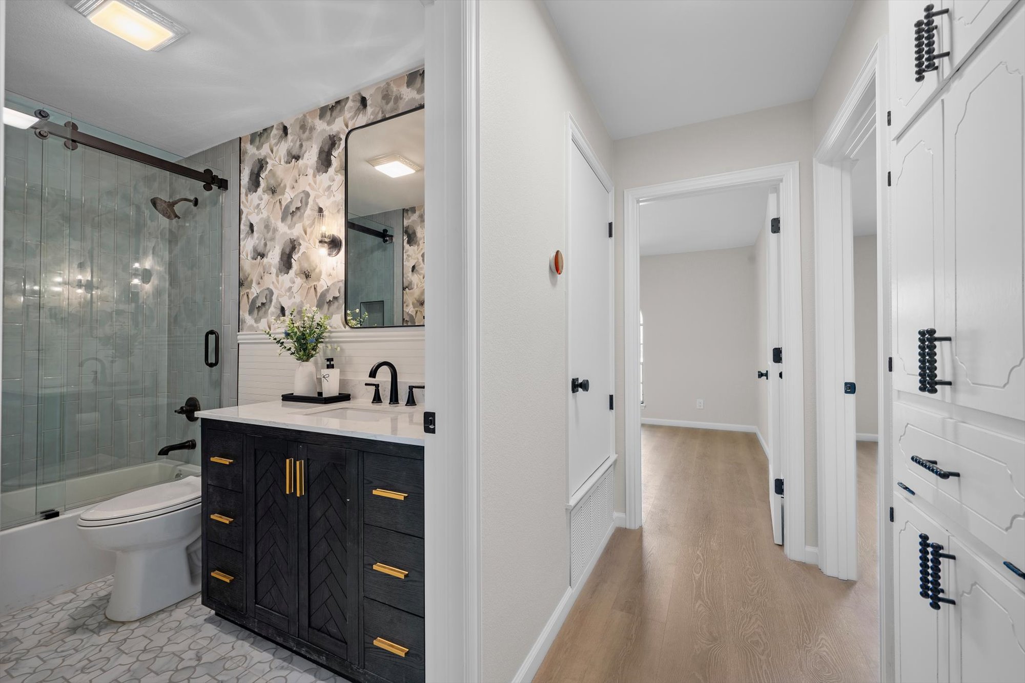 109 Woodland Road Georgetown, TX 78628 - Photo 30 of 40 Refined primary bath with sleek vanity, modern fixtures, and a glass-enclosed shower.