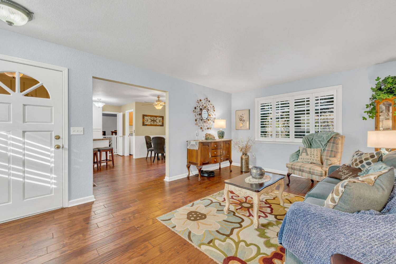 10092 Smith Road Grass Valley, CA 95949 - Photo 18 of 58 a living room with furniture large window and wooden floor