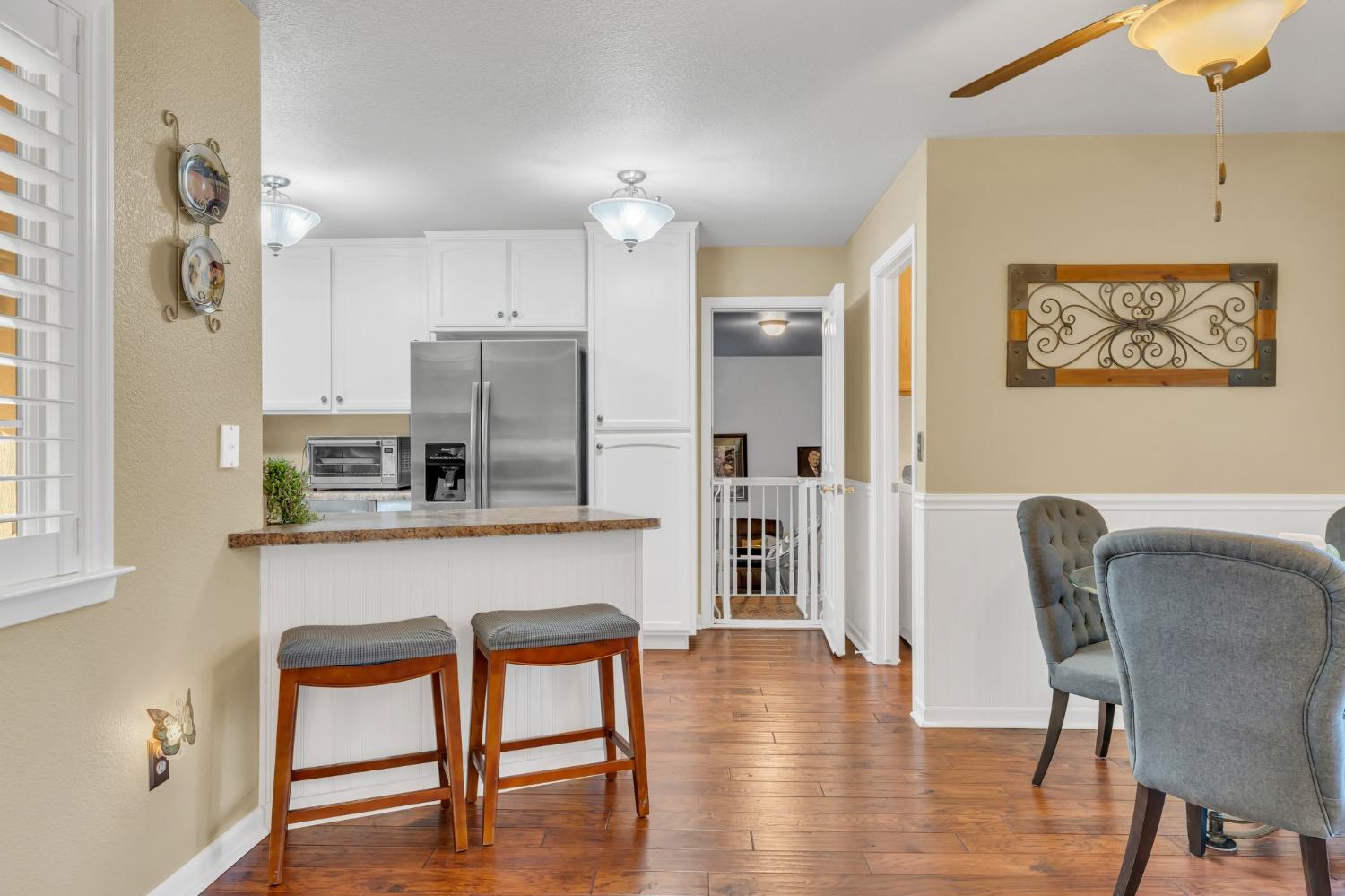 10092 Smith Road Grass Valley, CA 95949 - Photo 19 of 58 a kitchen with stainless steel appliances granite countertop a dining table chairs and a refrigerator