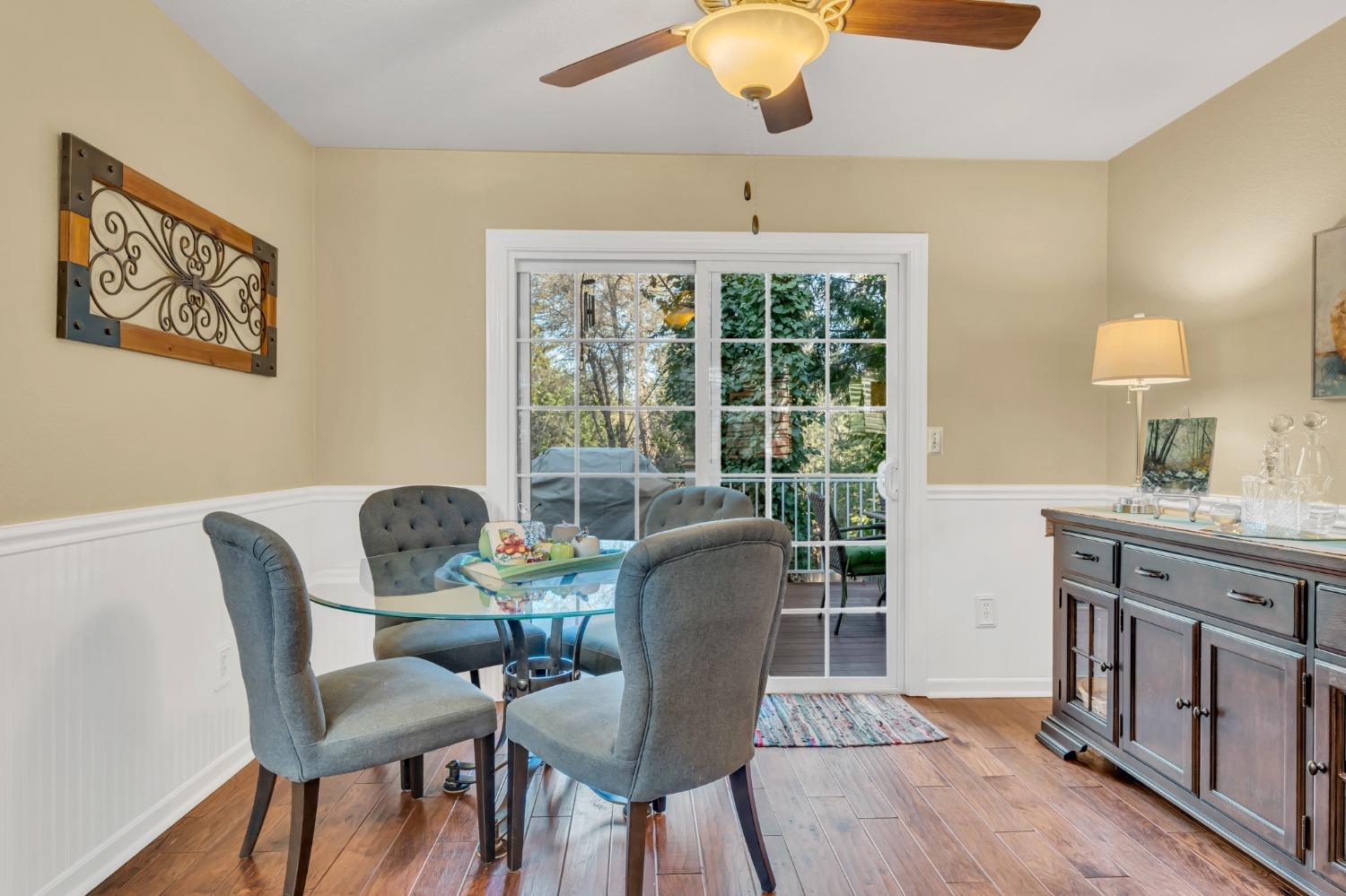 10092 Smith Road Grass Valley, CA 95949 - Photo 21 of 58 a dining room with furniture a chandelier and wooden floor