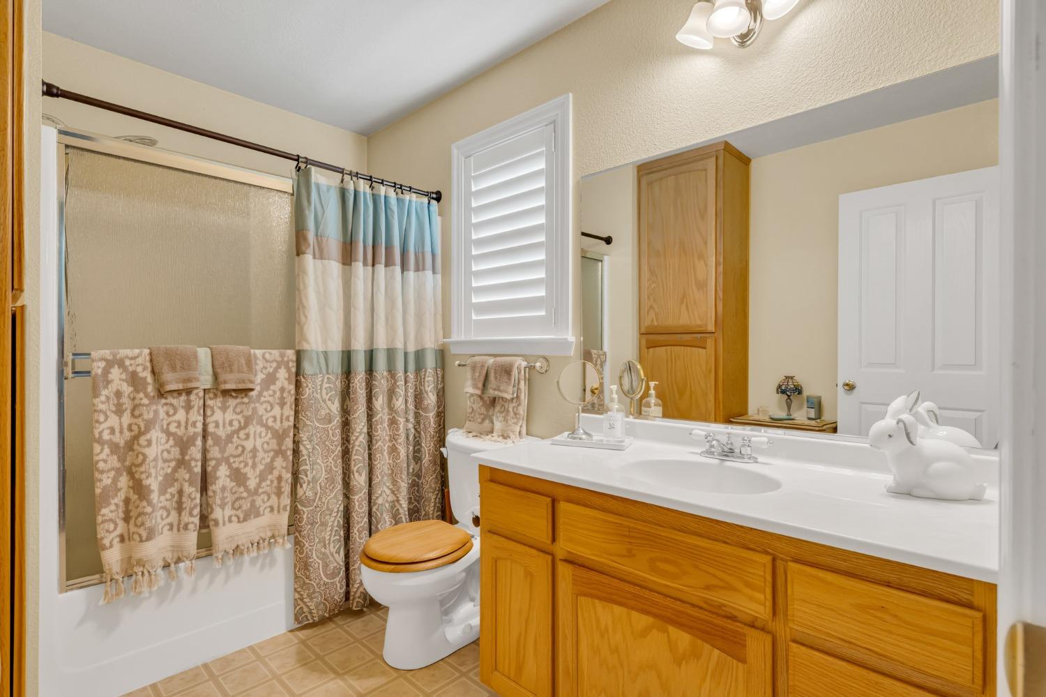 10092 Smith Road Grass Valley, CA 95949 - Photo 33 of 58 a bathroom with a granite countertop sink toilet and shower