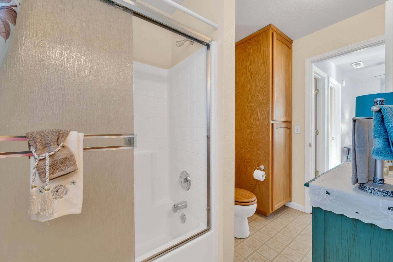 10092 Smith Road Grass Valley, CA 95949 - Photo 41 of 58 a bathroom with a granite countertop sink a toilet and shower