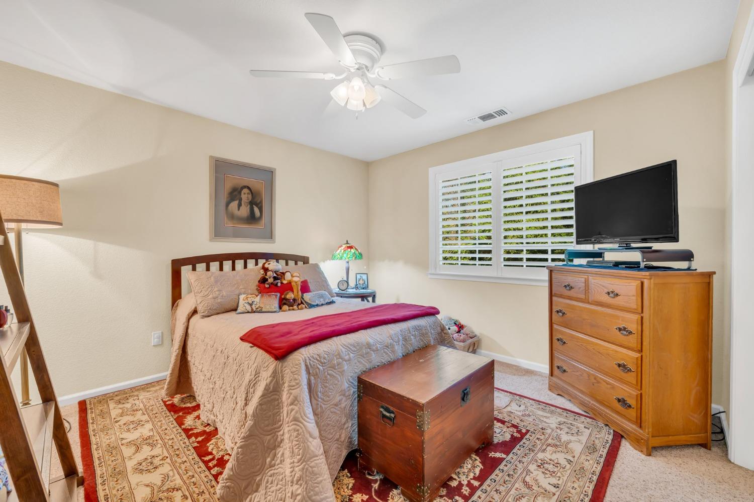 10092 Smith Road Grass Valley, CA 95949 - Photo 42 of 58 a bedroom with a bed and a flat screen tv