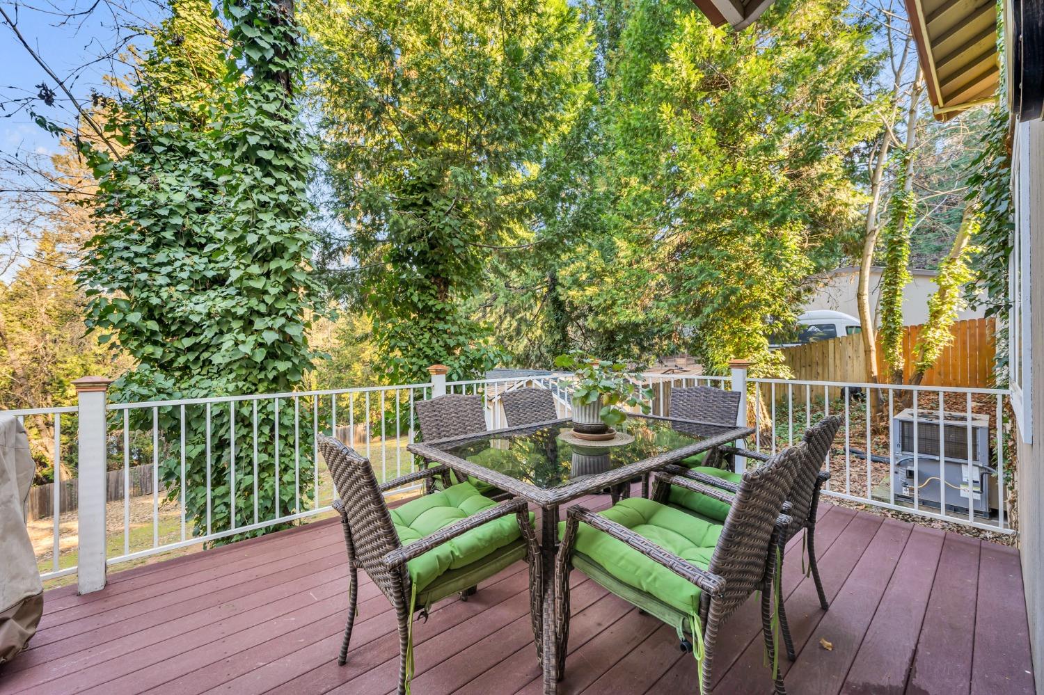 10092 Smith Road Grass Valley, CA 95949 - Photo 44 of 58 a balcony with wooden floor table and chairs