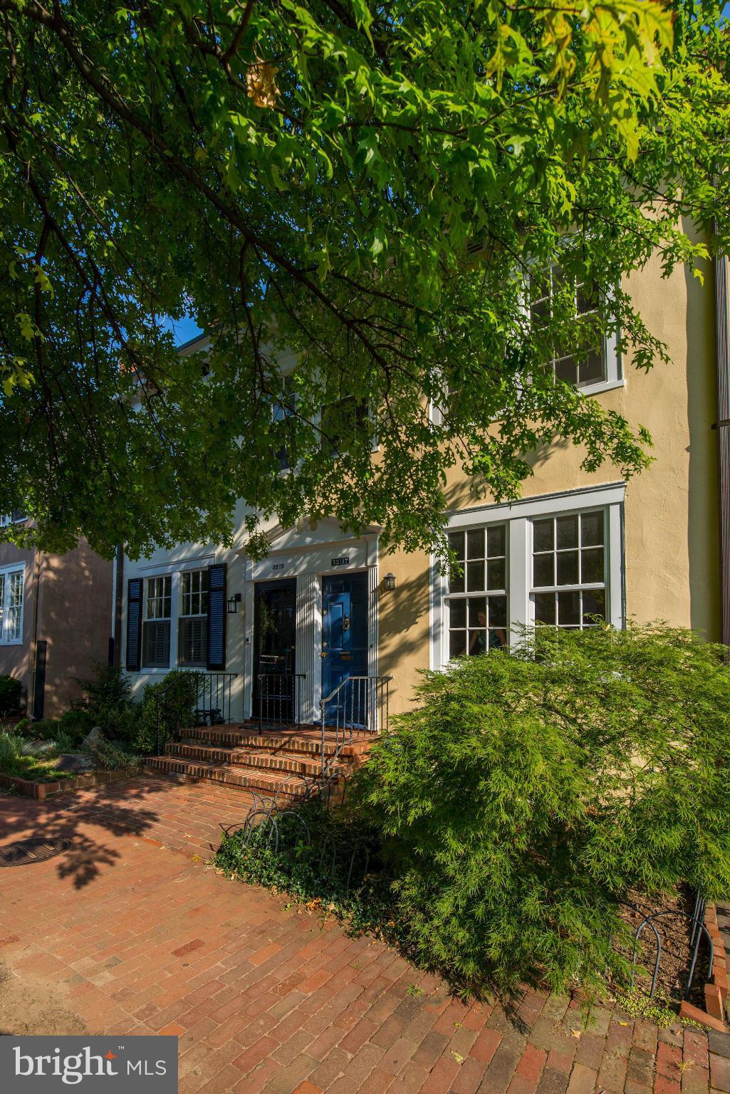 a front view of a house with garden and porch