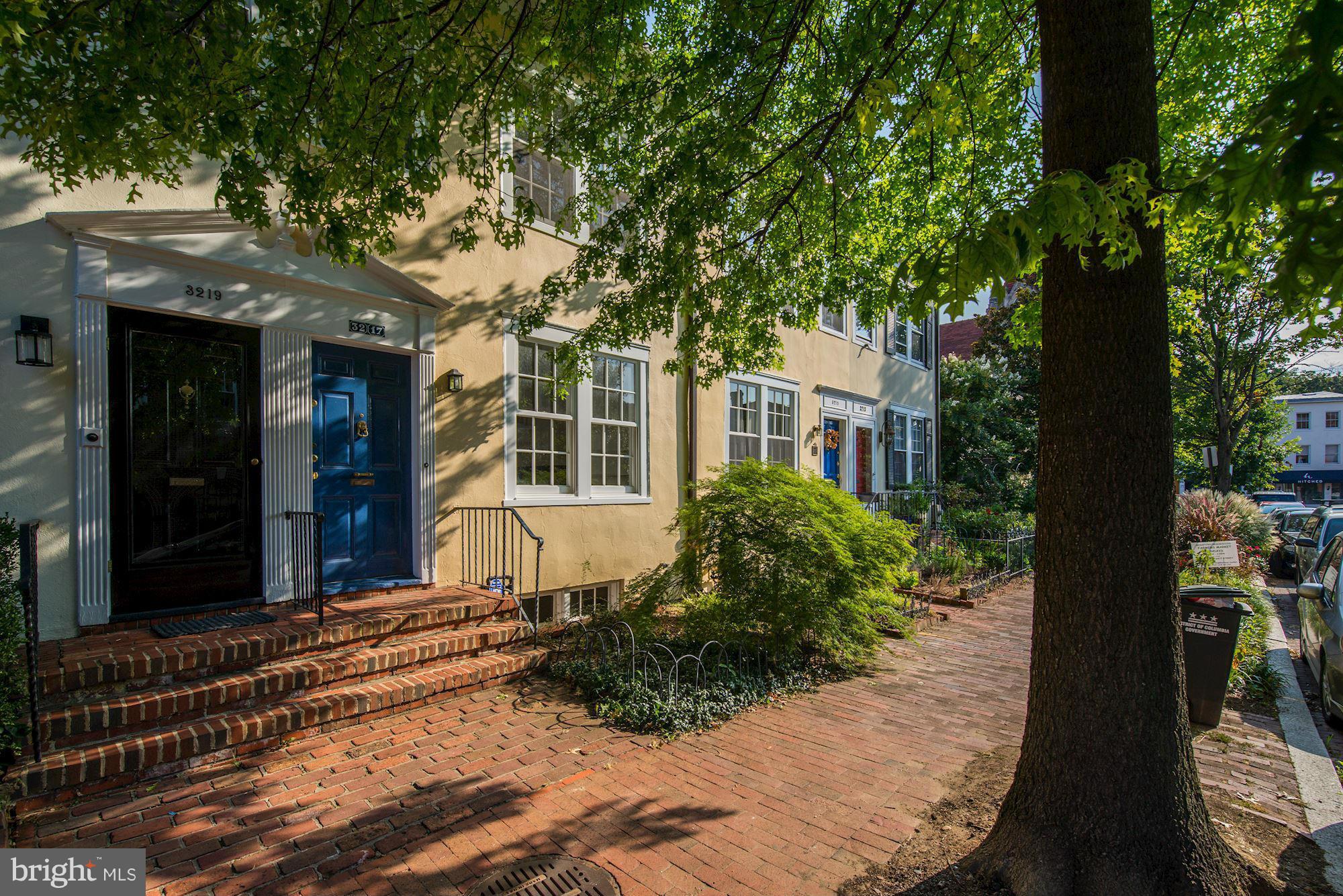 3217 Volta Place Northwest Washington, DC 20007 - Photo 2 of 21 a front view of a house with a yard