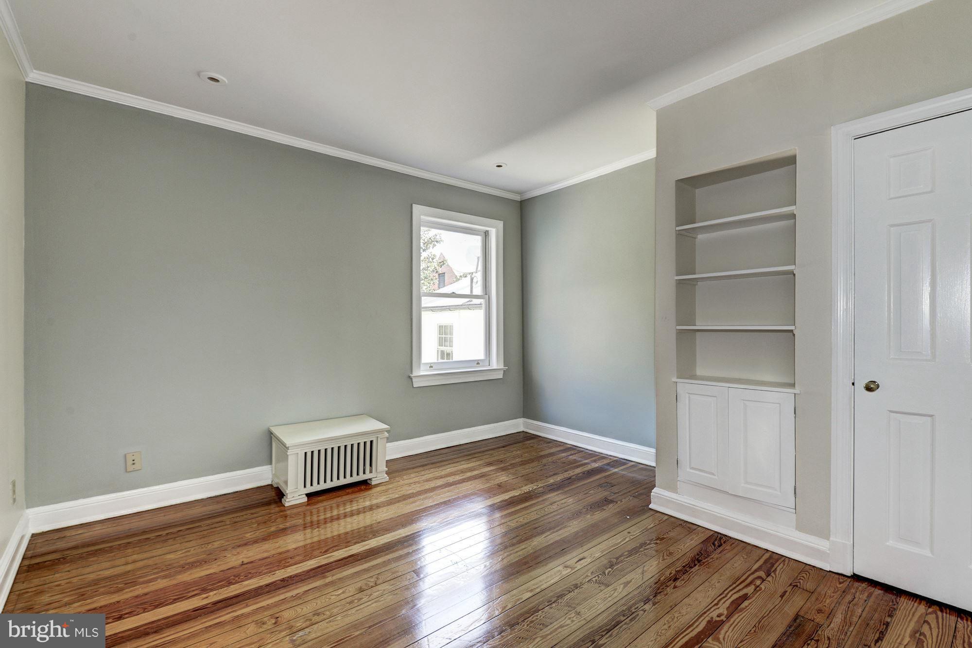3217 Volta Place Northwest Washington, DC 20007 - Photo 11 of 21 a view of an empty room with a window and wooden floor