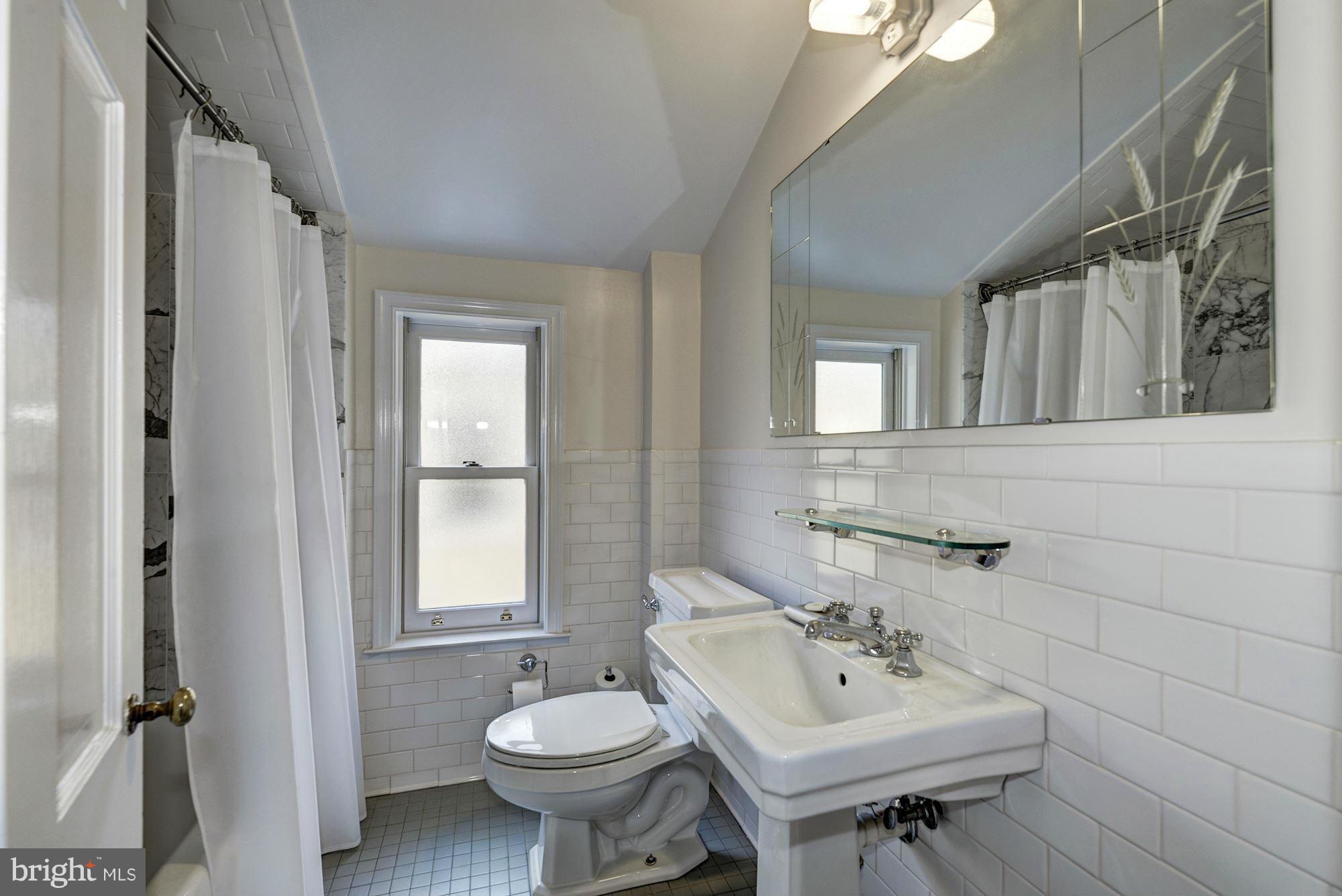3217 Volta Place Northwest Washington, DC 20007 - Photo 12 of 21 a bathroom with a sink mirror and a toilet