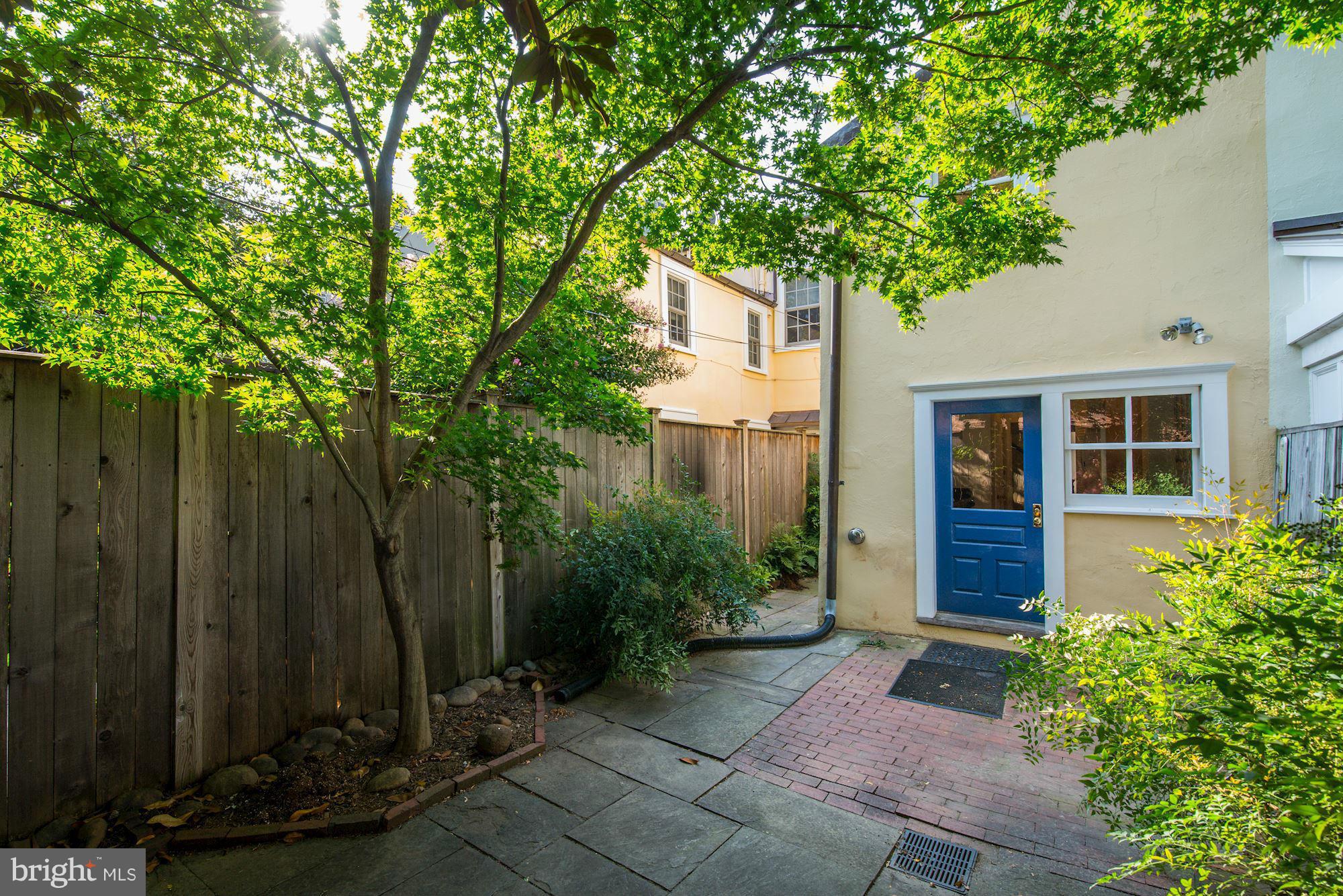 3217 Volta Place Northwest Washington, DC 20007 - Photo 18 of 21 a front view of a house with a garden