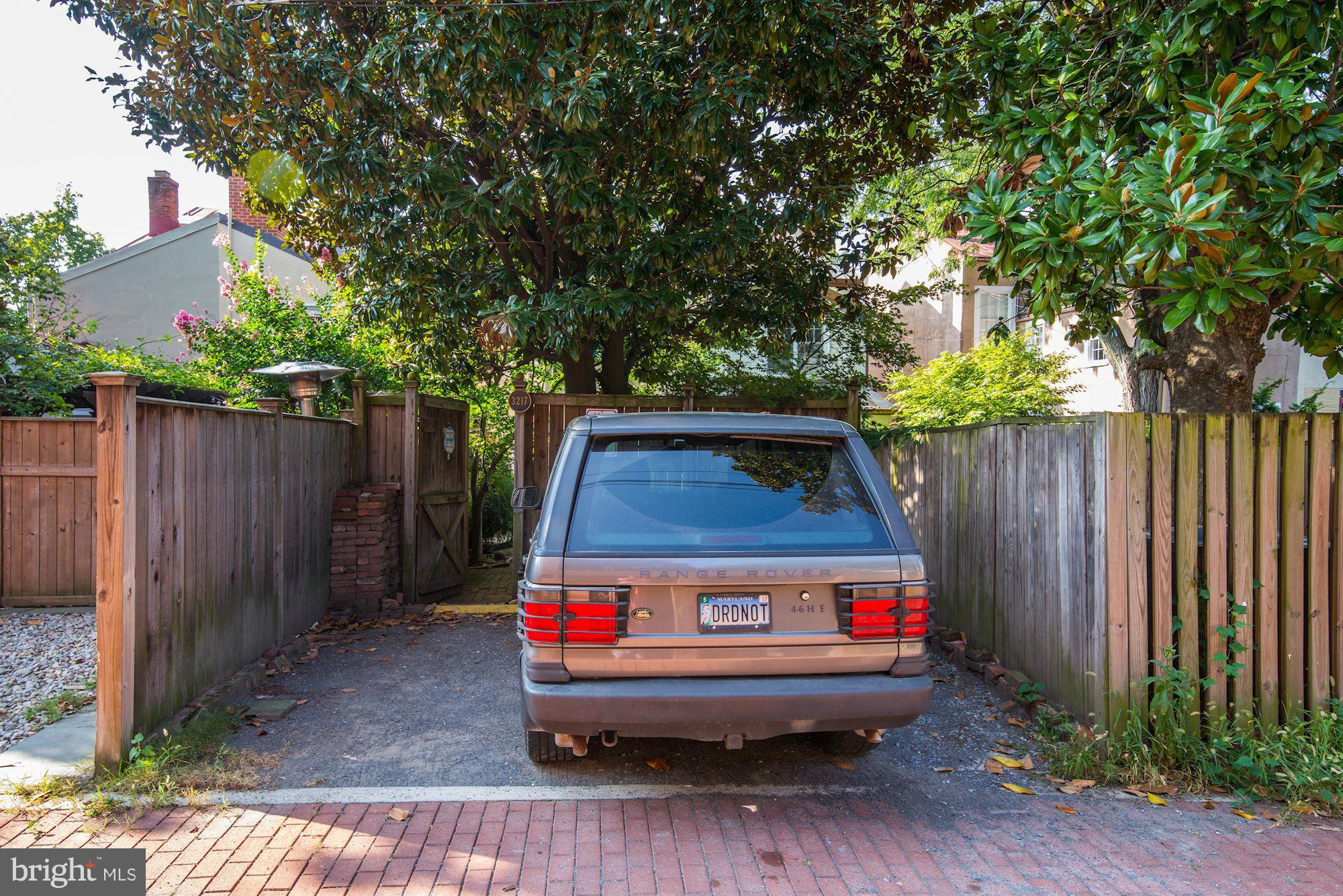 3217 Volta Place Northwest Washington, DC 20007 - Photo 19 of 21 a wooden bench sitting in front of a house