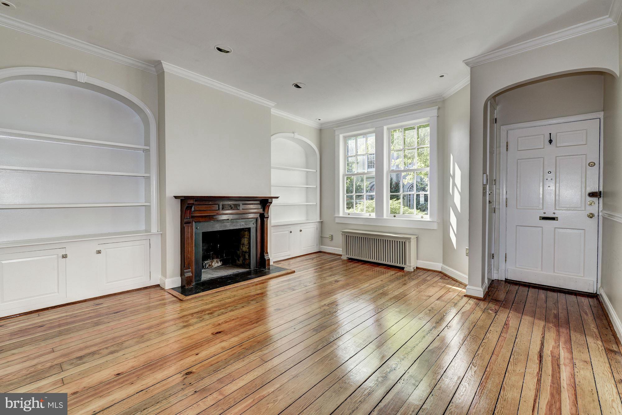3217 Volta Place Northwest Washington, DC 20007 - Photo 3 of 21 a view of a livingroom with wooden floor and a fireplace
