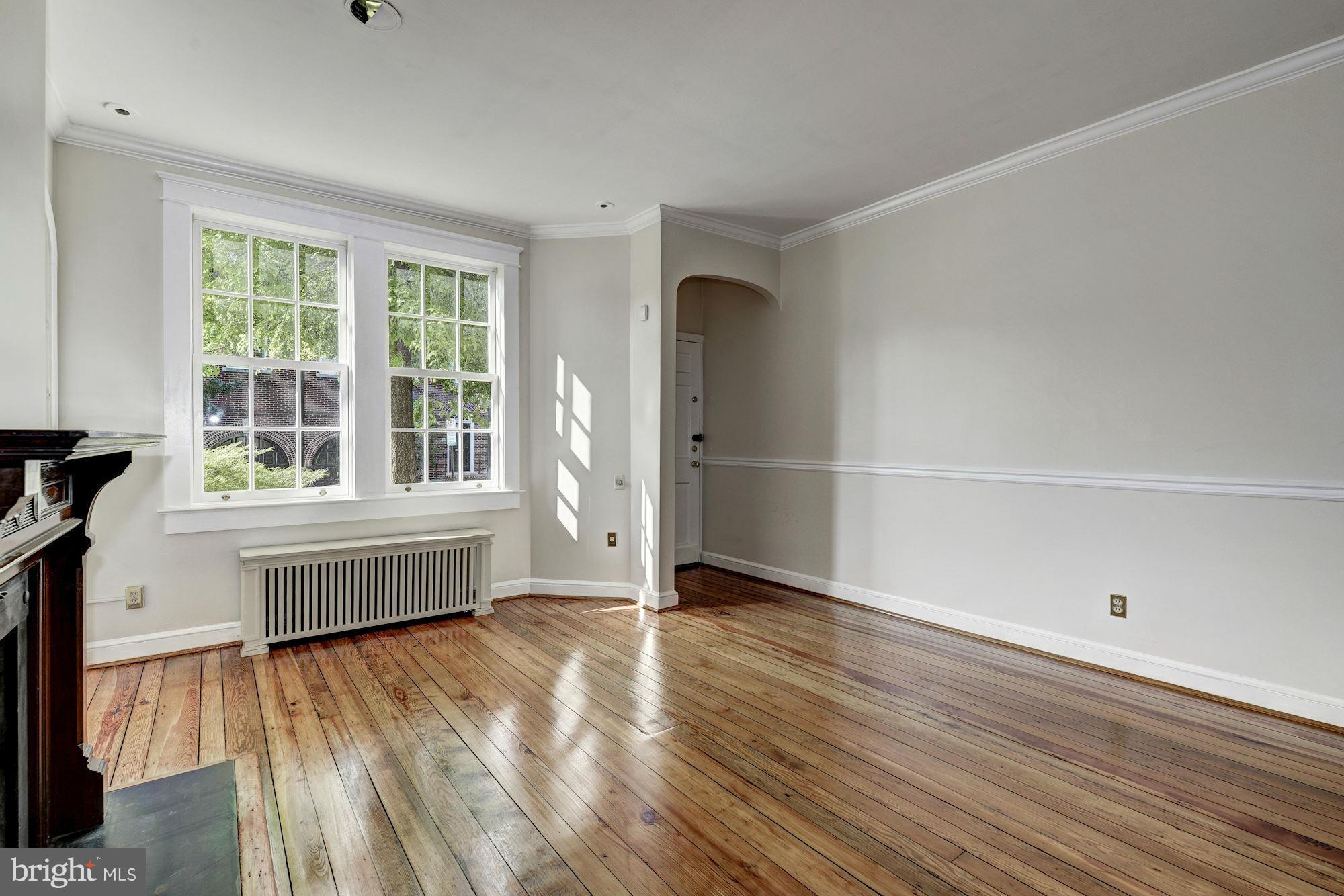 3217 Volta Place Northwest Washington, DC 20007 - Photo 4 of 21 an empty room with wooden floor and windows