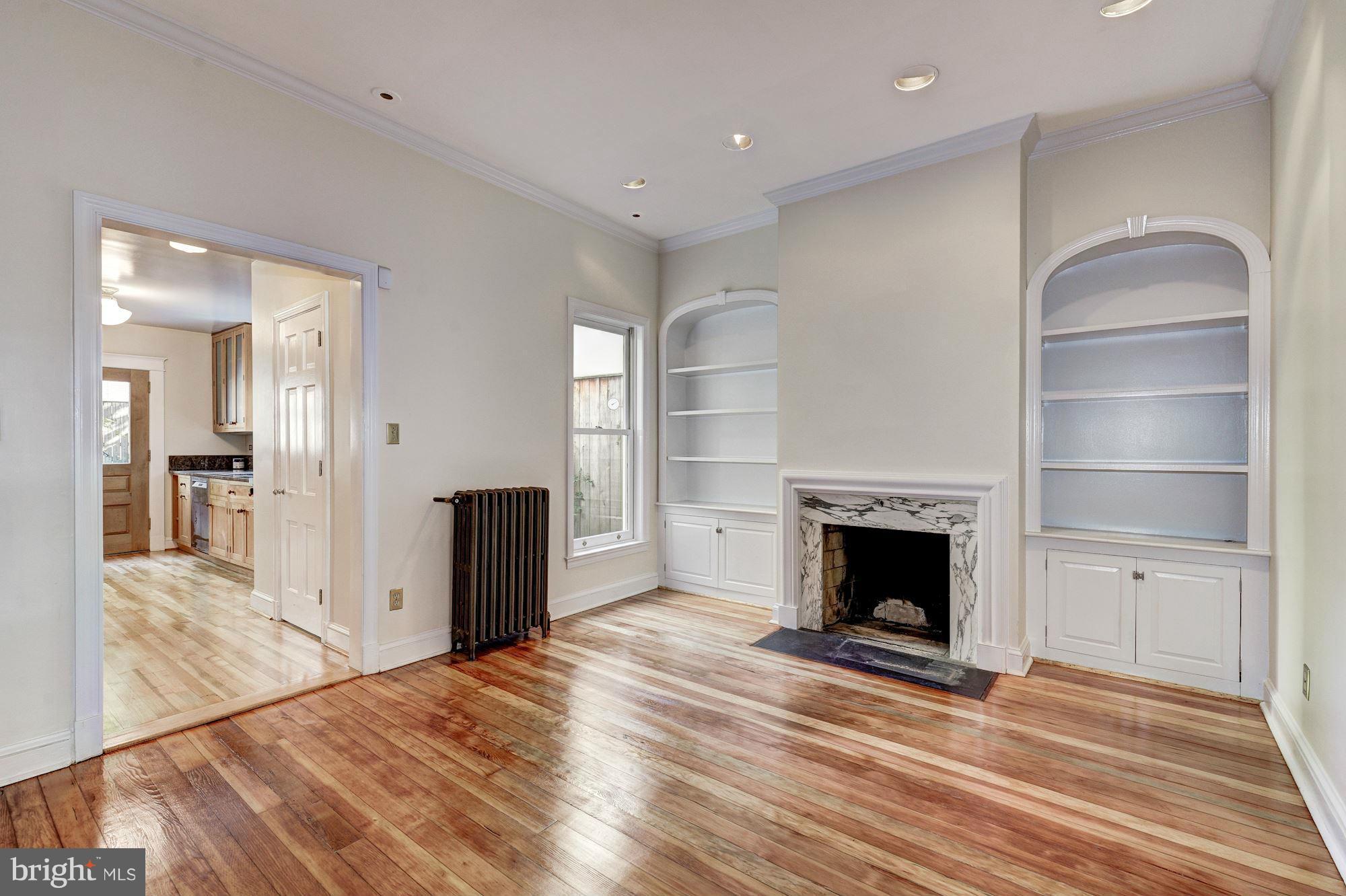 3217 Volta Place Northwest Washington, DC 20007 - Photo 6 of 21 a view of a livingroom with a fireplace wooden floor and window