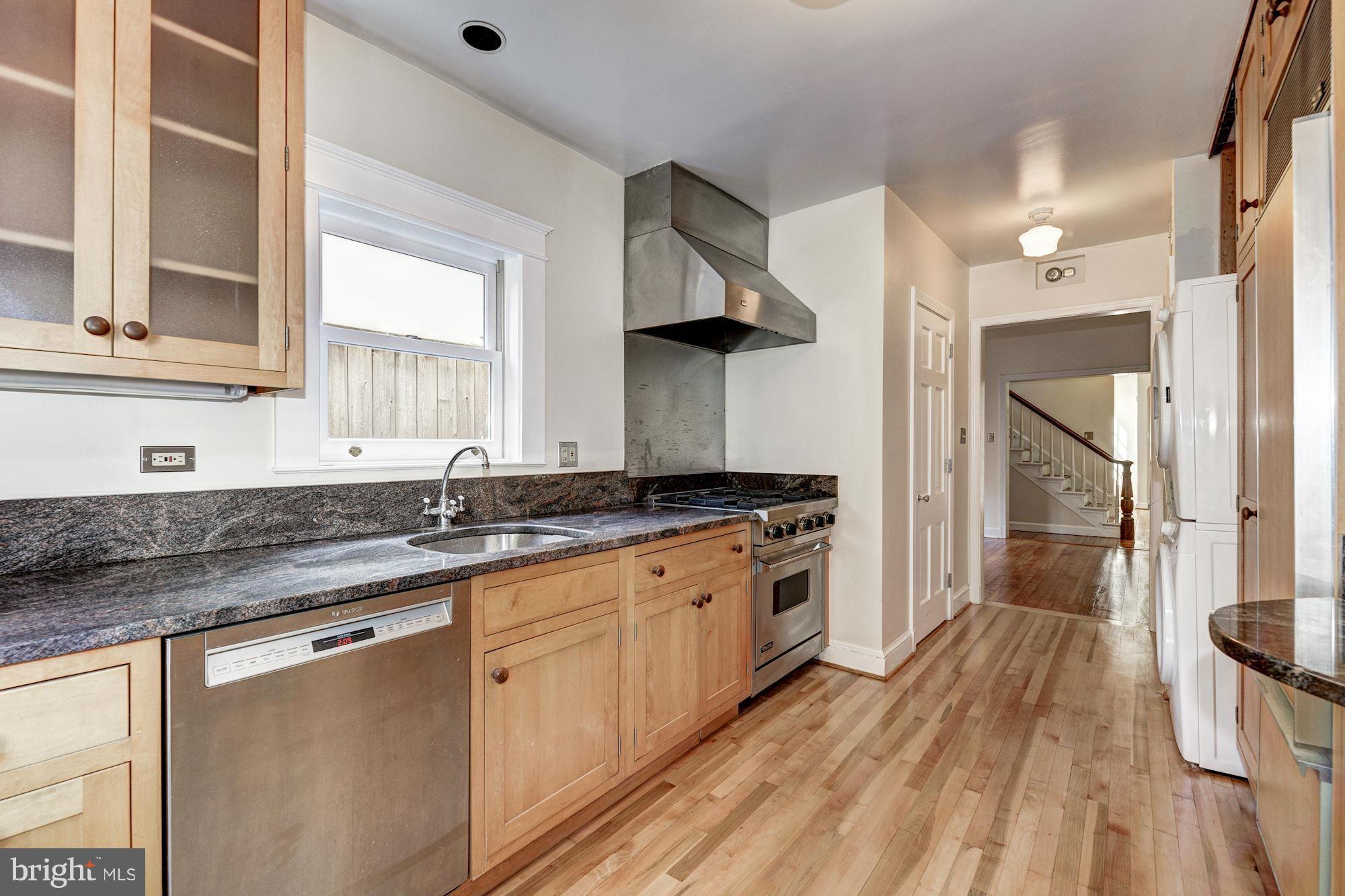 3217 Volta Place Northwest Washington, DC 20007 - Photo 8 of 21 a kitchen with granite countertop a sink cabinets and wooden floor