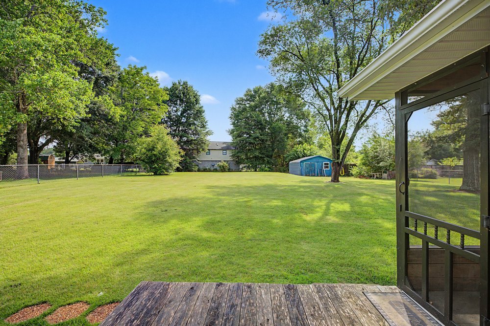 115 Brunson Drive Pickens, SC 29671 - Photo 28 of 29 A spacious backyard with mature trees and a sturdy storage shed, perfect for outdoor activities.
