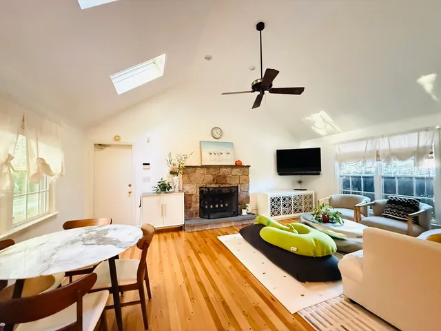 a living room with furniture a fireplace and a flat screen tv