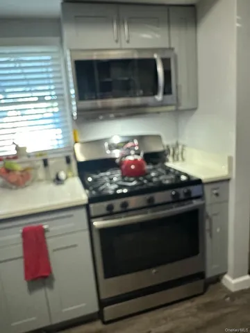 a stove top oven sitting inside of a kitchen