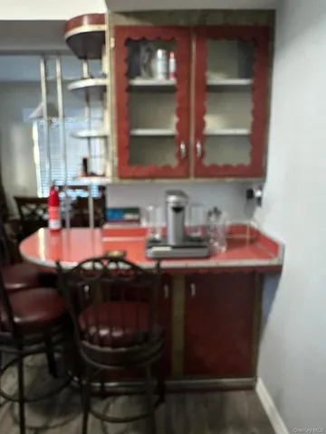 a kitchen with a sink and a stove with chairs