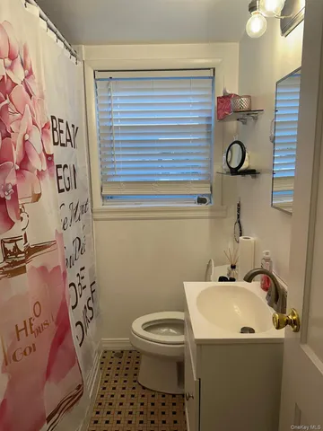 a bathroom with a sink and mirror with toilet