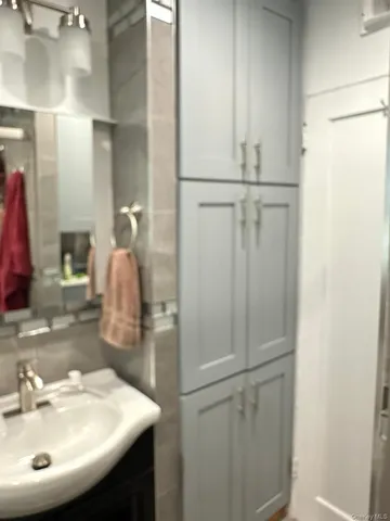 a bathroom with a sink and mirror