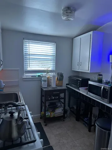 a kitchen with wooden cabinets and a stove top oven