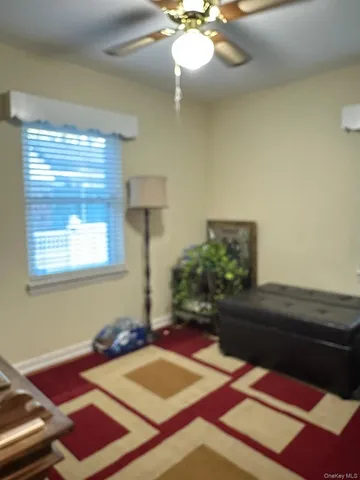 a bedroom with a bed and a lamp on dresser